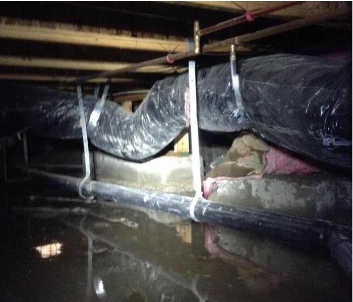 flood in crawlspace showing supports and plumbing