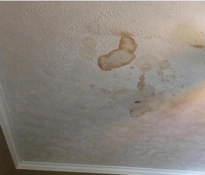 water stained and water damaged white ceiling