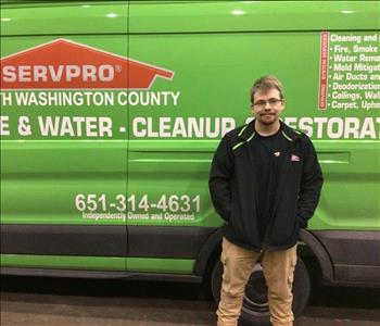 jesse posing in front of servpro truck