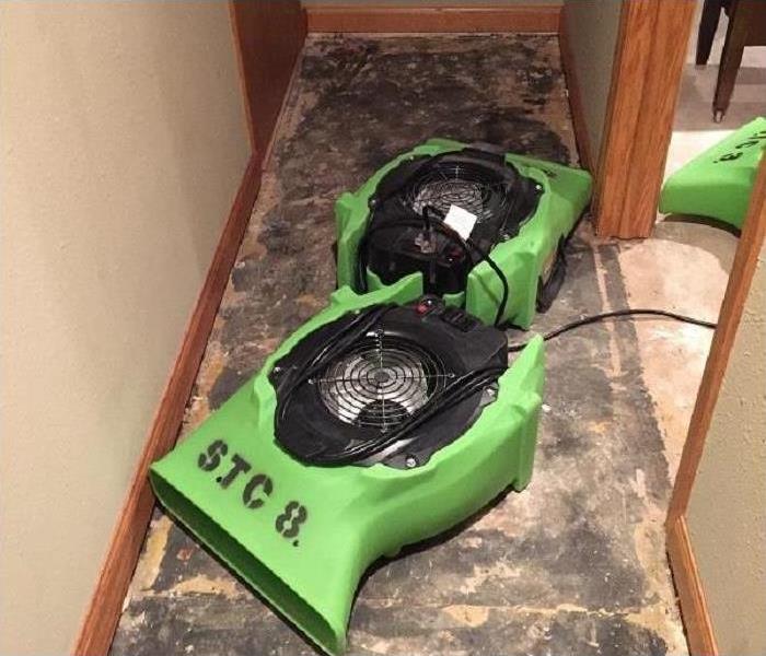 three air movers by a small closet opening, carpet removed